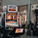 A collection of slot machines is situated inside a building with bright, colorful screens displaying various games and gaming themes. A person is seated nearby, seemingly relaxed with luggage beside them, and the atmosphere is lively with electronic displays.